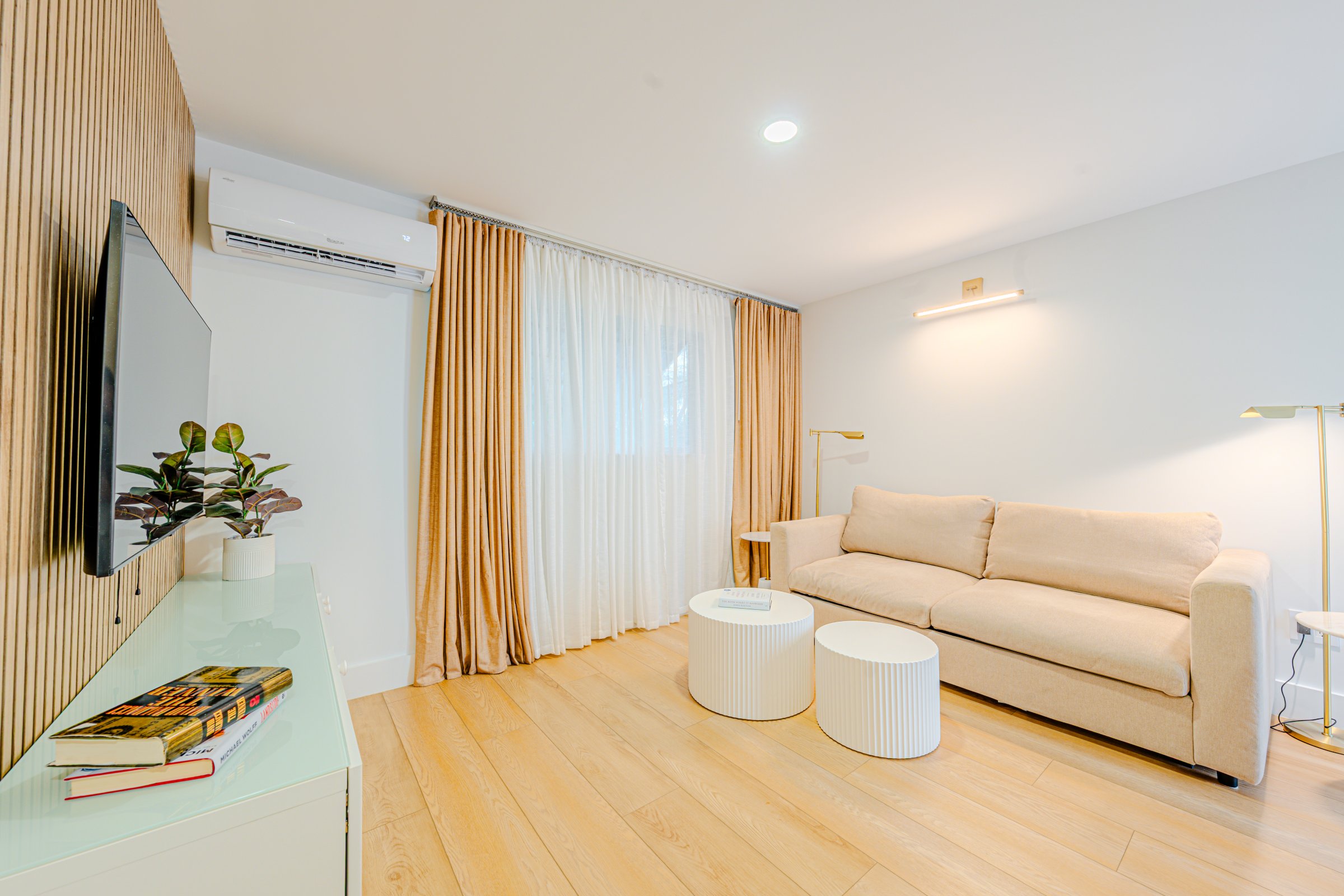 A living room with a sofa, coffee table, and TV